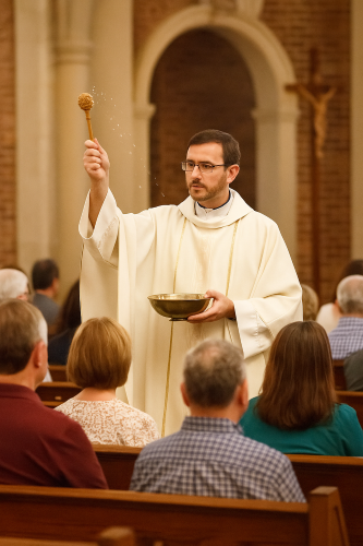 Priest blessing congregation
